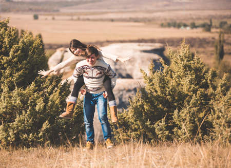 young beautiful loving couple in hipster fashion style posing on mountain. outdoor close up portraitの写真素材