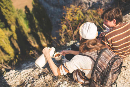 Family on autumn hike. Young parents with kid hiking next to a mountain.の写真素材