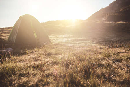Camping green camp on the grass at sunrise time. Mountains and lake of Bulgaria.の写真素材