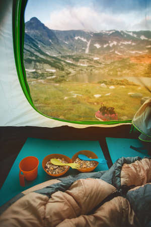 Morning breakfast open air - oatmeal with dried fruit and a cup of tea.の写真素材