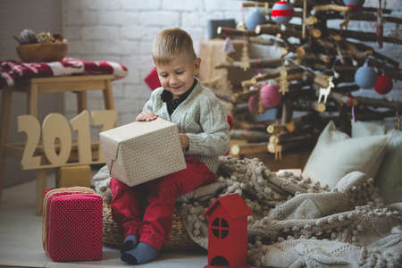 Portrait of little boy near fashion xmas treeの写真素材