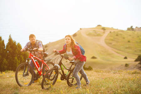 family concept. happy family  riding bikes at the mountain