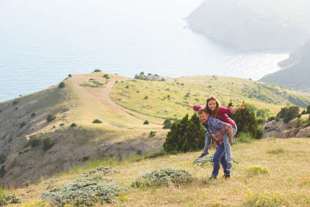 Beautiful loving couple in hipster fashion style posing on mountainの写真素材