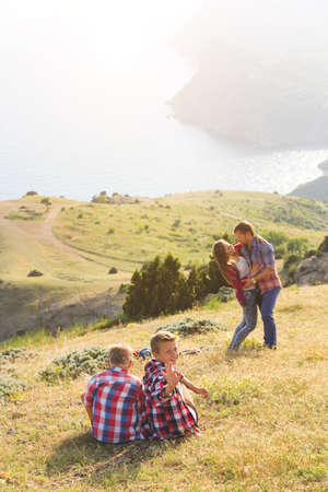 happy family of four people looking to beautiful seascape in mountains. family conceptの写真素材