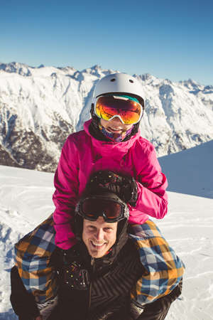 Happy couple of snowboarders in the alpine mountainsの写真素材