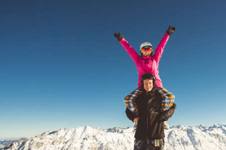 Happy couple of snowboarders in the alpine mountainsの写真素材