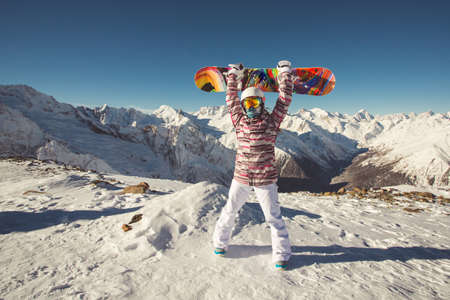 Female snowboarder in the alpine mountainsの写真素材