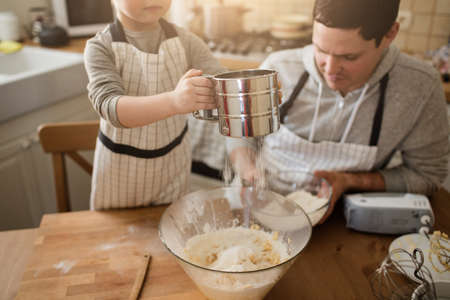 A father and his son cookingの写真素材