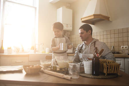 A father and his son cookingの写真素材