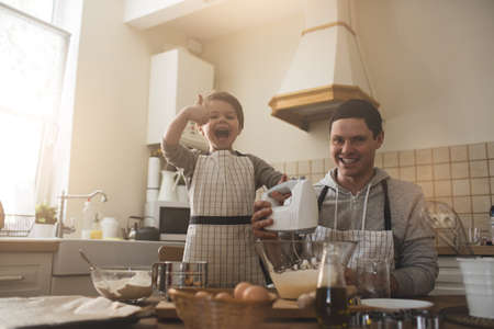 A father and his son cookingの写真素材