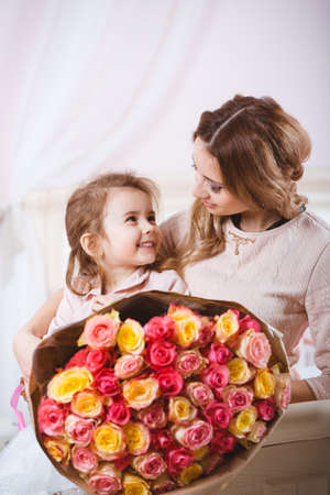 Smiling mother with daughter portraitの写真素材