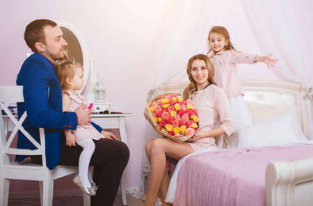 Young loving family portrait in bedroomの写真素材