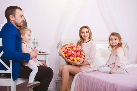 Young loving family portrait in bedroomの写真素材