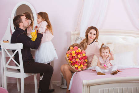 Young loving family portrait in bedroomの写真素材