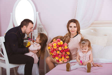 Young loving family portrait in bedroomの写真素材