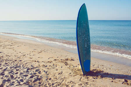 Sea shore. Nature background with surf board in vintage styleの写真素材