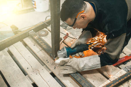 Man doing electroshooting of parts on the steel structure in the factoryの写真素材