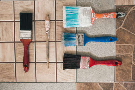 Paint brushes on the old tile backgroundの写真素材