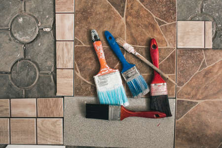 Paint brushes on the old tile backgroundの写真素材