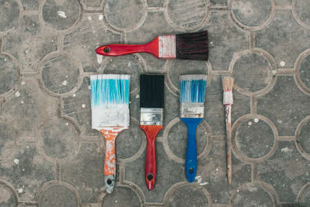 Multicolored brushes on a stone floor. Top viewの写真素材