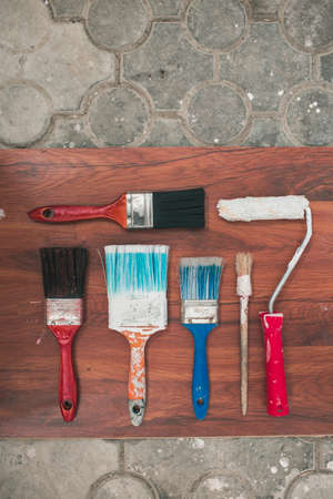 Paint brushes on the old wooden backgroundの写真素材