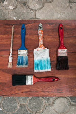 Paint brushes on the old wooden background