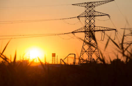 Transmission power line silhouette on sunsetの写真素材
