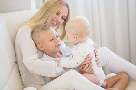 Portrait of young beautiful mother with two sonsの写真素材