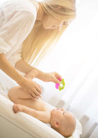 Portrait of young beautiful mother with baby sonの写真素材