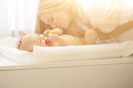 Portrait of young beautiful mother with baby sonの写真素材