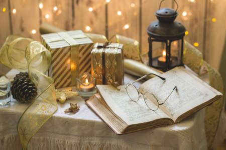 Holy bible book with eyeglasses. Christmas lights on background.の写真素材