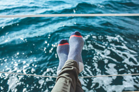 Closeup on women's feet in socks on the yacht, lifestyle, pleasure concept. carefree vacationの写真素材