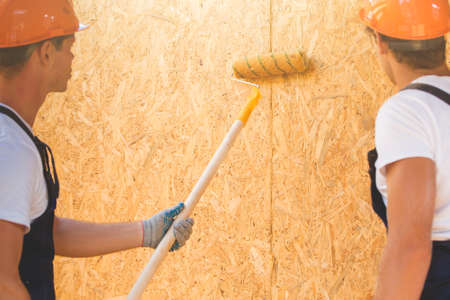 Two young man building wooden house. Ecology concept.の写真素材