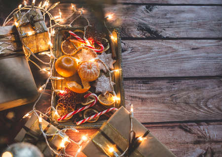 Christmas frame with lights, ornaments, candy and decorations. Free space