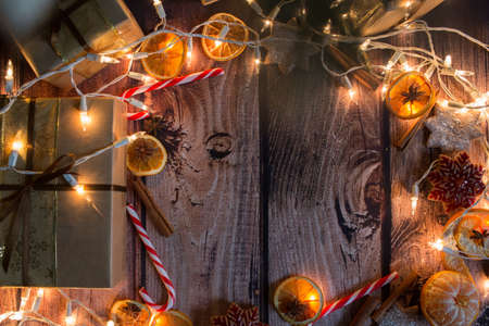 Christmas frame with lights, ornaments, candy and decorations. Free space