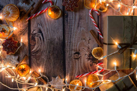 Christmas frame with lights, ornaments, candy and decorations. Free space