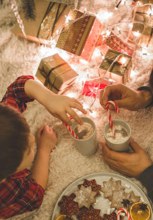 Father and son laying under christmas tree.の写真素材
