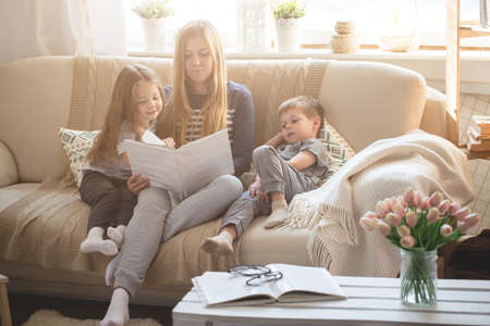 Happy family reading books togetherの写真素材