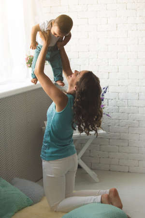 A young mother and son having fun togetherの写真素材