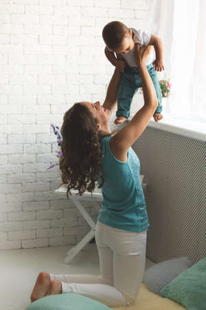 A young mother and son having fun togetherの写真素材