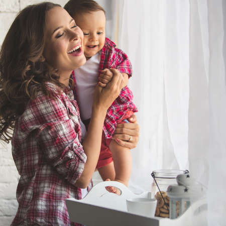 A young mother and son having fun togetherの写真素材