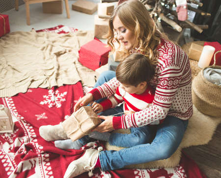 Portrait of happy mother and son on the background of the Christmas tree in new year room. The idea for postcardsの写真素材