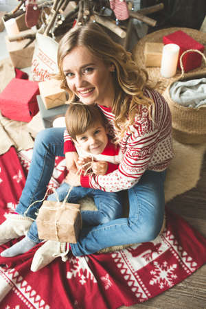 Portrait of happy mother and son on the background of the Christmas tree in new year room. The idea for postcardsの写真素材