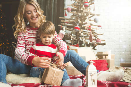 Portrait of happy mother and son on the background of the Christmas tree in new year room. The idea for postcardsの写真素材