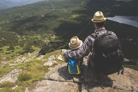 Father and son traveling in Rila mountains Bulgariaの写真素材