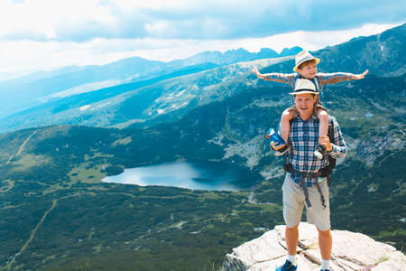 Father and son traveling in Rila mountains Bulgariaの写真素材