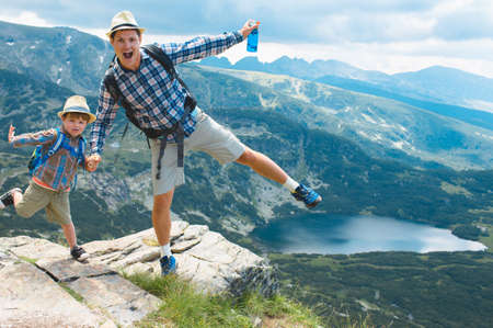 Father and son traveling in Rila mountains Bulgariaの写真素材