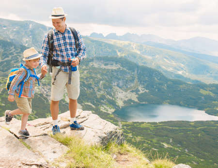 Father and son traveling in Rila mountains Bulgariaの写真素材