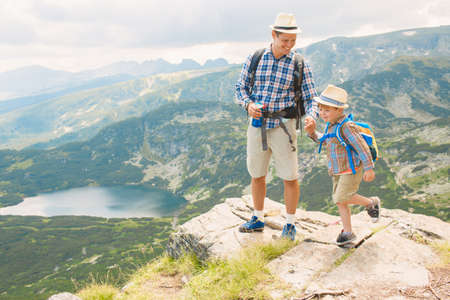 Father and son traveling in Rila mountains Bulgariaの写真素材