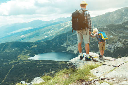 Father and son traveling in Rila mountains Bulgariaの写真素材